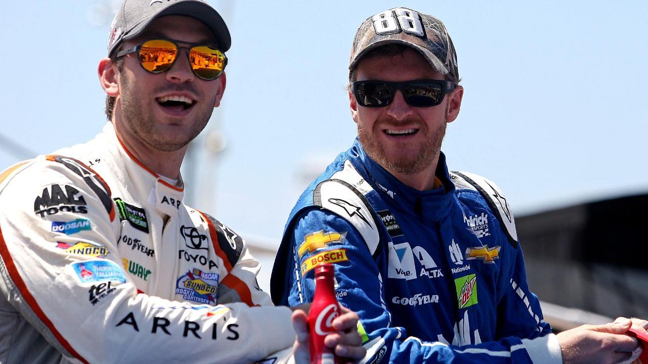 Dale Earnhardt Jr. talks with NASCAR Cup Series driver Daniel Suarez (19) before the Toyota Owners 400 at Richmond International Raceway.