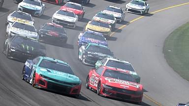 The field accelerates through turn one on a restart in stage two of NASCAR's FireKeepers Casino 400 at Michigan International Speedway.