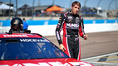 Mar 8, 2025; Avondale, AZ, USA; NASCAR Cup Series driver Carson Hocevar (77) during qualifying for the Shrines Children’s 500 at Phoenix Raceway. Mandatory Credit: Gary A. Vasquez-Imagn Images