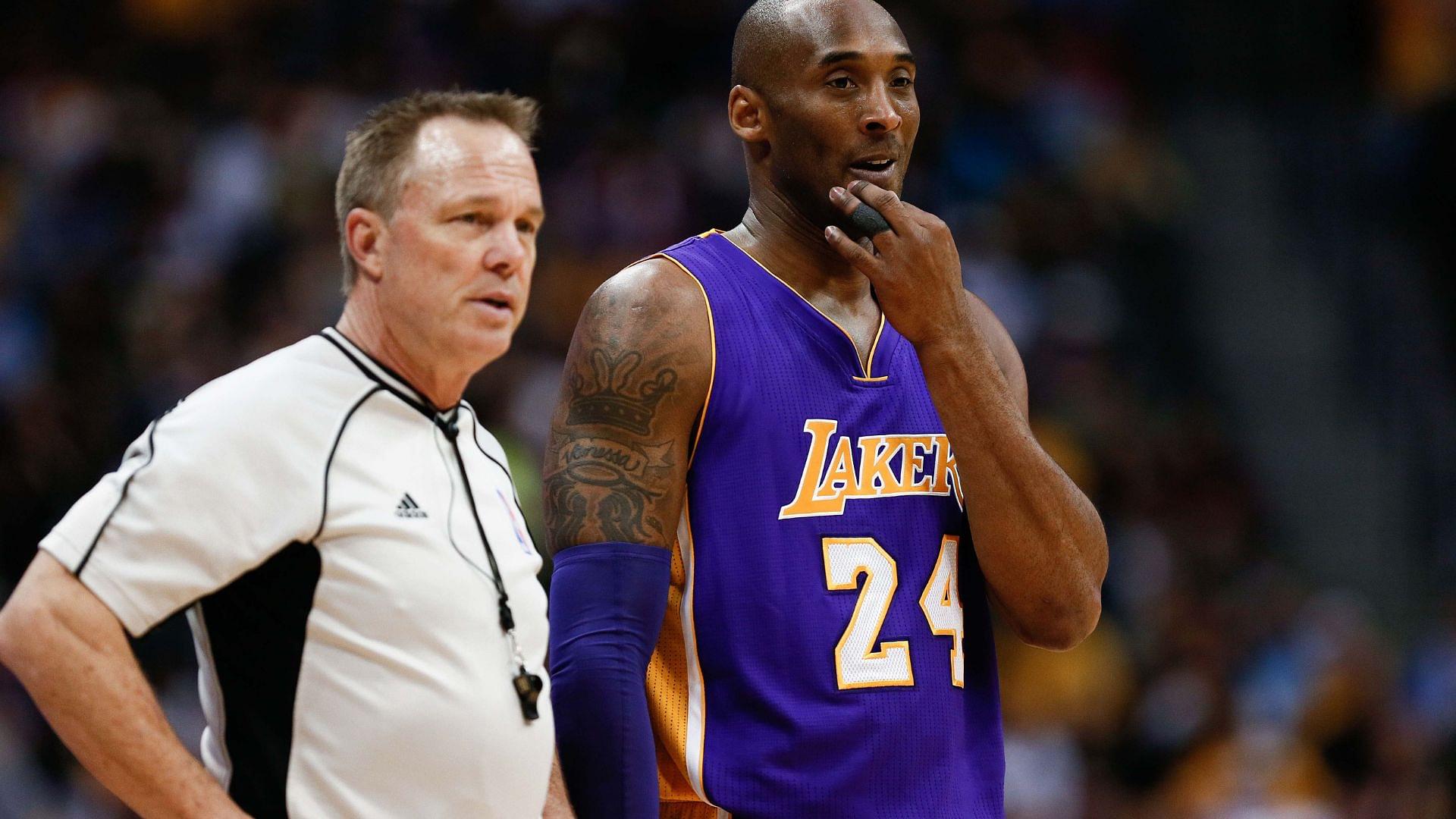 Mar 2, 2016; Denver, CO, USA; Los Angeles Lakers forward Kobe Bryant (24) talks with referee Bill Spooner (22) in the first quarter of the game against the Denver Nuggets at the Pepsi Center.