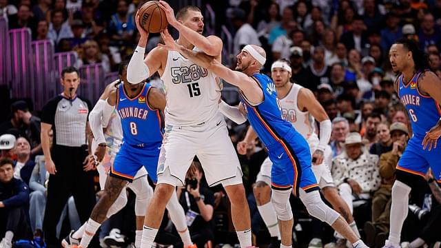 Denver Nuggets center Nikola Jokic (15) controls the ball under pressure form Oklahoma City Thunder guard Alex Caruso (9) in the second quarter during game six of the second round for the 2025 NBA Playoffs at Ball Arena.