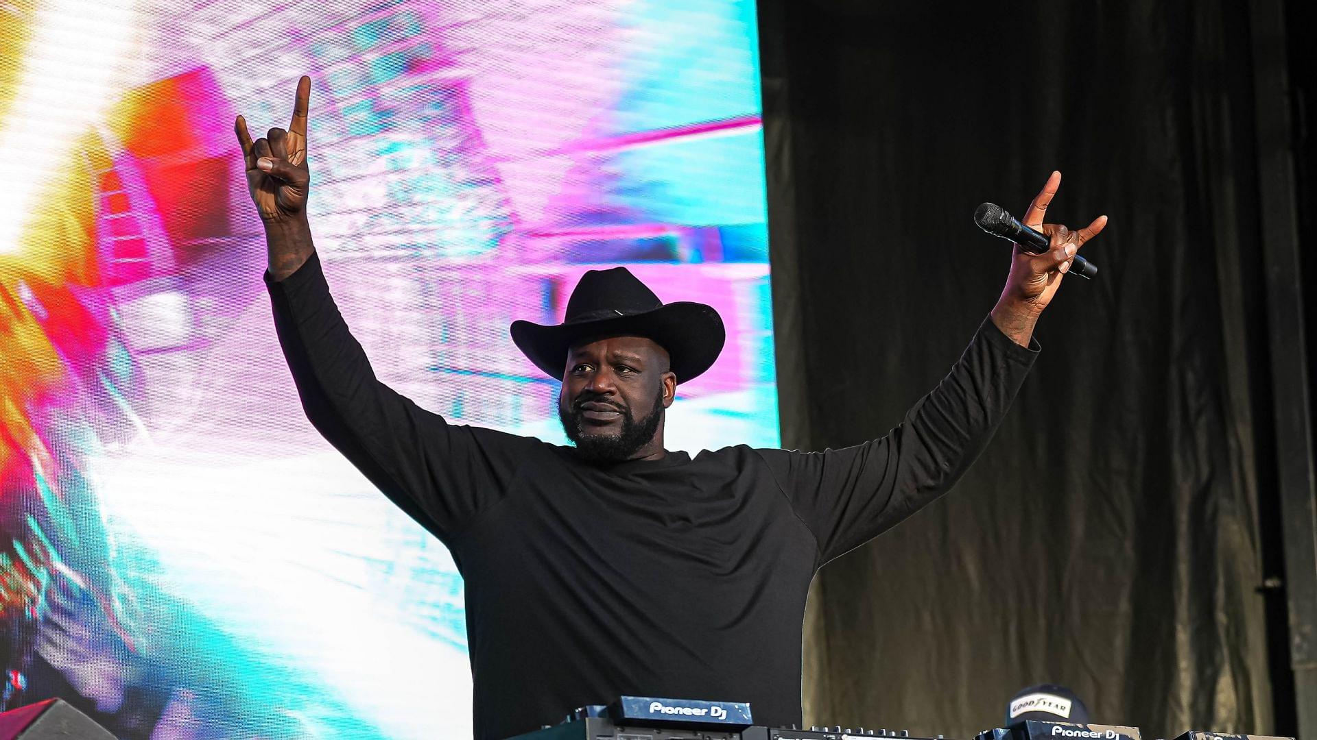 Shaquille O'Neal holds up the sign of the horns during a DJ performance ahead of the College Football Playoff semifinal game between the Texas Longhorns and Ohio State in the Cotton Bowl at AT&T Stadium on Friday, Jan. 10, 2024 in Arlington, Texas.