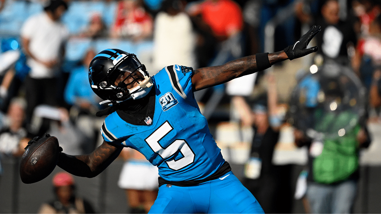 Carolina Panthers wide receiver Diontae Johnson (5) celebrates by throwing the ball into the crowd after scoring a thouchdown