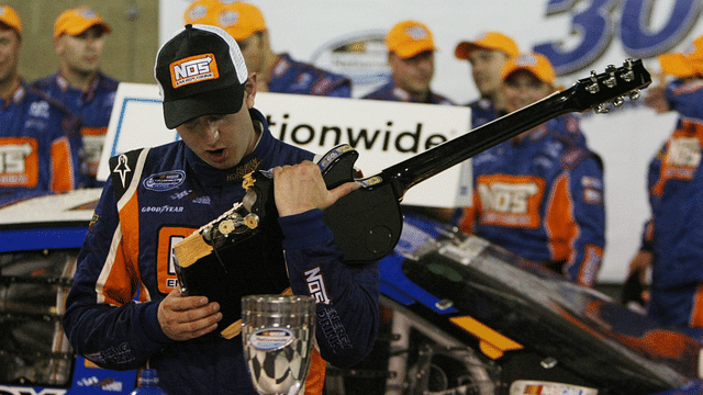 Kyle Busch smashes a Gibson guitar in Victory Lane at 14th Annual Federated Auto Parts 300 to be held June 6 at the Nashville Speedway in Gladeville, Tenn on June 6,2009.