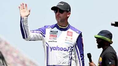 NASCAR Cup Series driver Denny Hamlin (11) greets the crowd during driver introductions before the start of the FireKeepers Casino 400 at Michigan International Speedway.