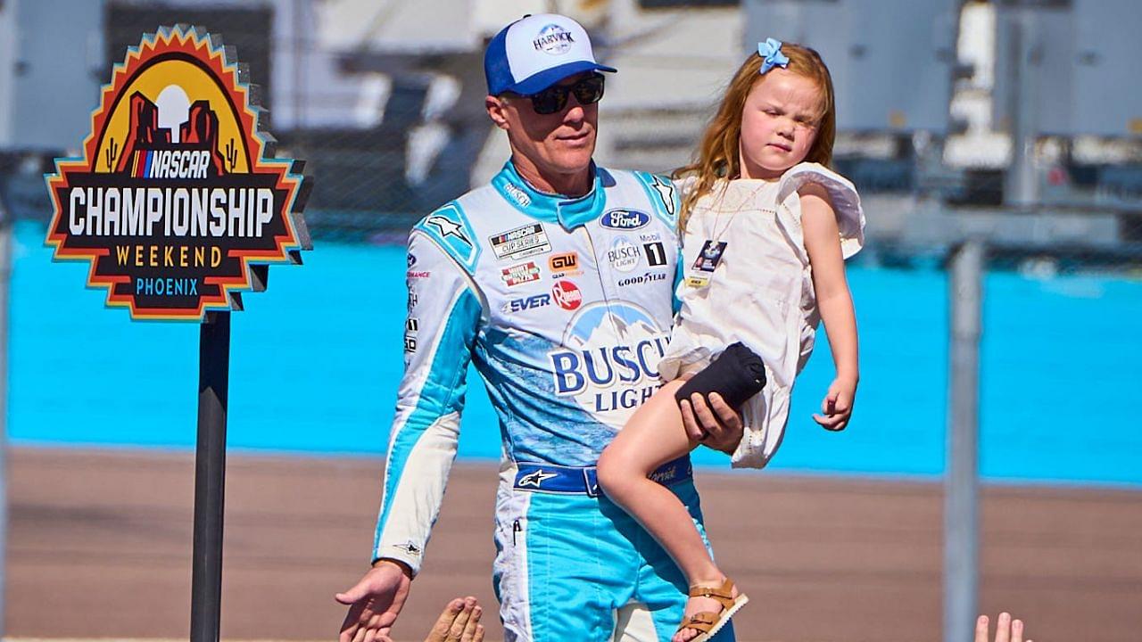 Holding his daughter Piper, NASCAR Cup Series driver Kevin Harvick (4) walks the catwalk during the driver introductions for the Cup Series Championship race at Phoenix Raceway in Avondale on Nov. 5, 2023.