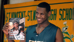 LeBron James holds an issue of Sports Illustrated on Feb. 13, 2002. James was on SI’s cover as a junior at St. Vincent-St. Mary High School.
