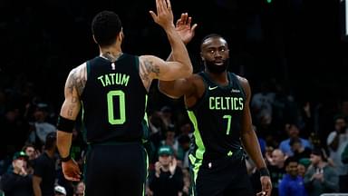 Boston Celtics guard Jaylen Brown (7) high fives forward Jayson Tatum (0) after the Cleveland Cavaliers called a timeout during the first quarter at TD Garden