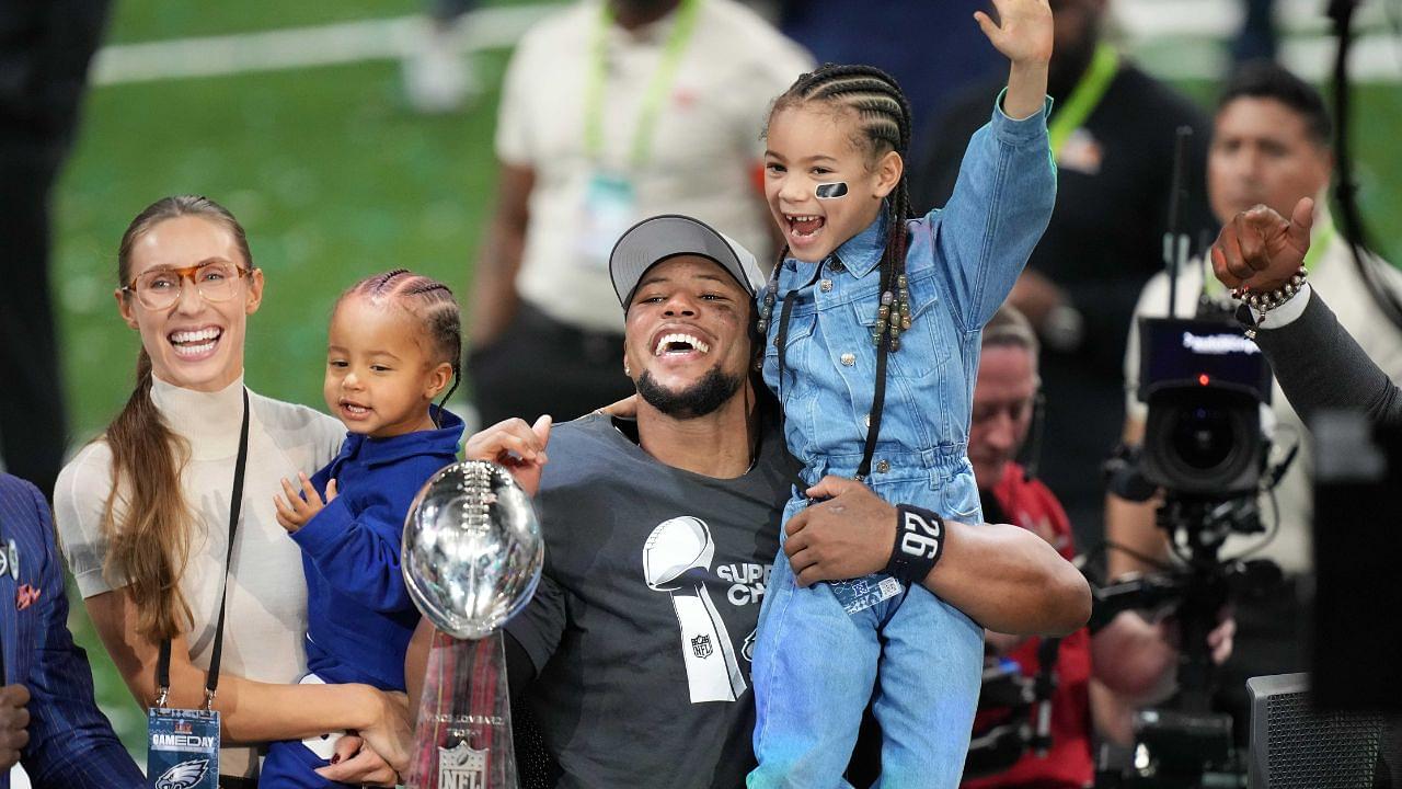 Philadelphia Eagles running back Saquon Barkley celebrates with fiancee Anna Congdon, son Saquon Barkley Jr.,2, and daughter Jada Barkley 6, after the Philadelphia Eagles 40-22 victory over the Kansas City Chiefs in Super Bowl LIX at the Caesars Superdome.