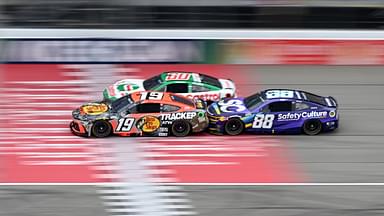NASCAR Cup Series drivers Chase Briscoe (19) Ryan Preece (60) and Shane van Gisbergen (88) race bumper to bumper down the main straightaway during stage three of the FireKeepers Casino 400 at Michigan International Speedway.