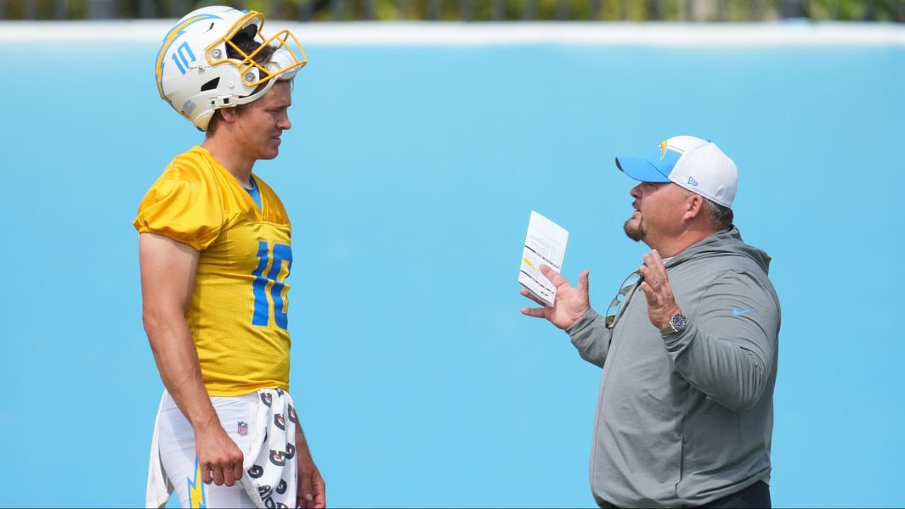 Los Angeles Chargers quarterback Justin Herbert (10) interacts with offensive coordinator Greg Roman during minicamp at the Hoag Performance Center.