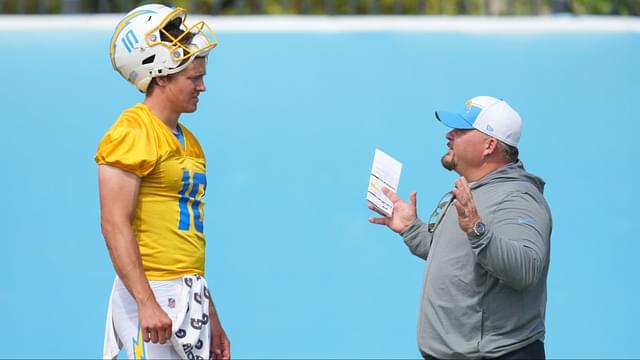 Los Angeles Chargers quarterback Justin Herbert (10) interacts with offensive coordinator Greg Roman during minicamp at the Hoag Performance Center.