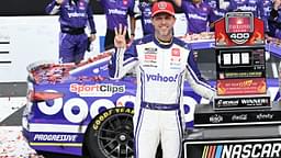 NASCAR Cup Series driver Denny Hamlin (11) celebrates with his team, holding up three fingers, one for each of his victories at Michigan International Speedway, after winning the FireKeepers Casino 400.