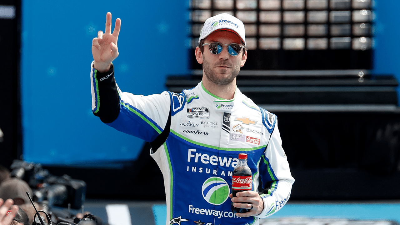 Feb 16, 2025; Daytona Beach, Florida, USA; NASCAR Cup Series driver Daniel Suarez (99) walks onto the driver introduction stage to greet fans before the Daytona 500 at Daytona International Speedway. Mandatory Credit: Peter Casey-Imagn Images