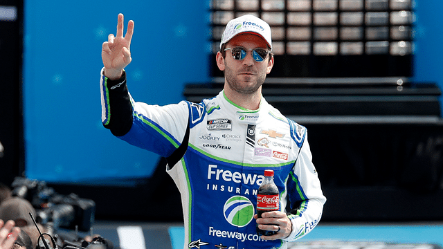 Feb 16, 2025; Daytona Beach, Florida, USA; NASCAR Cup Series driver Daniel Suarez (99) walks onto the driver introduction stage to greet fans before the Daytona 500 at Daytona International Speedway. Mandatory Credit: Peter Casey-Imagn Images