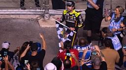 NASCAR Cup Series driver Ryan Blaney (12) heads into the stands to give away the checkered flag after winning the Cracker Barrel 400 NASCAR Cup Series race at Nashville Superspeedway in Lebanon, Tenn., Sunday, June 1, 2025.