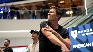 Tom Brady throws a football to a fan at American Dream during the grand opening of Card Vault by Tom Brady, a sports card and memorabilia retailer, East Rutherford, Friday, Apr. 11, 2025.