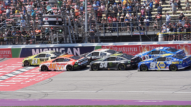 William Byron and Tyler Reddick lead the re-start during overtime of the FireKeepers Casino 400 at Michigan International Speedway.