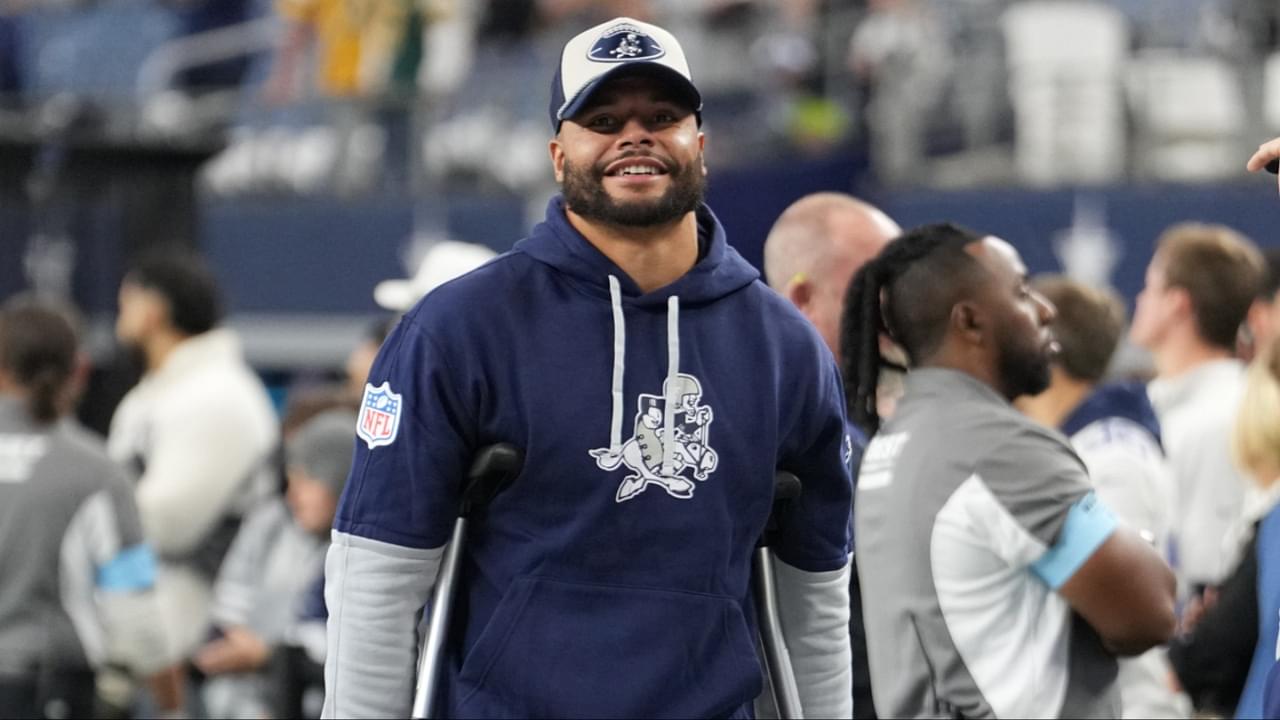 Dallas Cowboys quarterback Dak Prescott (left) stands on crutches before the game against the New York Giants at AT&T Stadium.