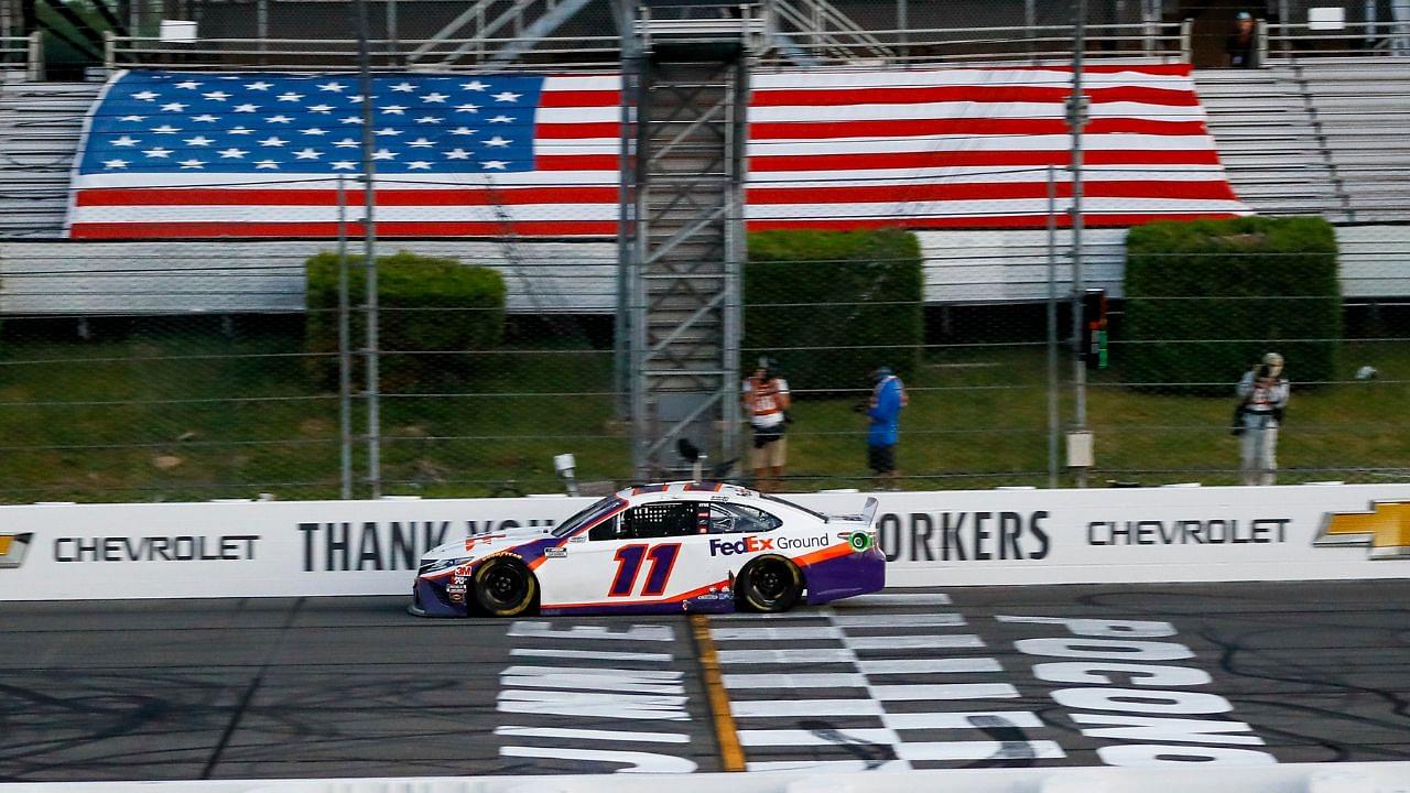 Denny Hamlin (11) crosses the finish line to win the Pocono 350 Cup Series at Pocono Raceway.