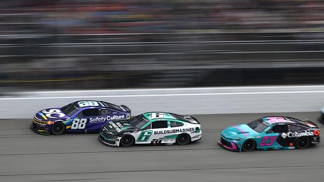 NASCAR Cup Series drivers Shane van Gisbergen (88) Brad Keselowski (6) and driver Bubba Wallace (23) race down the main straightaway during stage three of the FireKeepers Casino 400 at Michigan International Speedway.