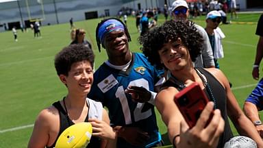 Jacksonville Jaguars wide receiver Travis Hunter (12), center, takes a selfie with brothers JJ Rivera, 14, left, and Gary DeLeon-Rivera during the second mandatory minicamp at Miller Electric Center Wednesday, June 11, 2025 in Jacksonville, Fla.