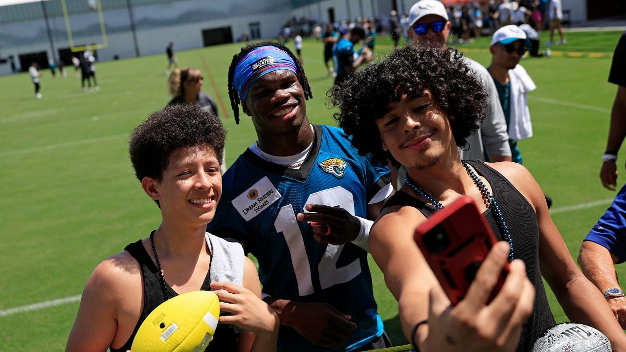 Jacksonville Jaguars wide receiver Travis Hunter (12), center, takes a selfie with brothers JJ Rivera, 14, left, and Gary DeLeon-Rivera during the second mandatory minicamp at Miller Electric Center Wednesday, June 11, 2025 in Jacksonville, Fla.