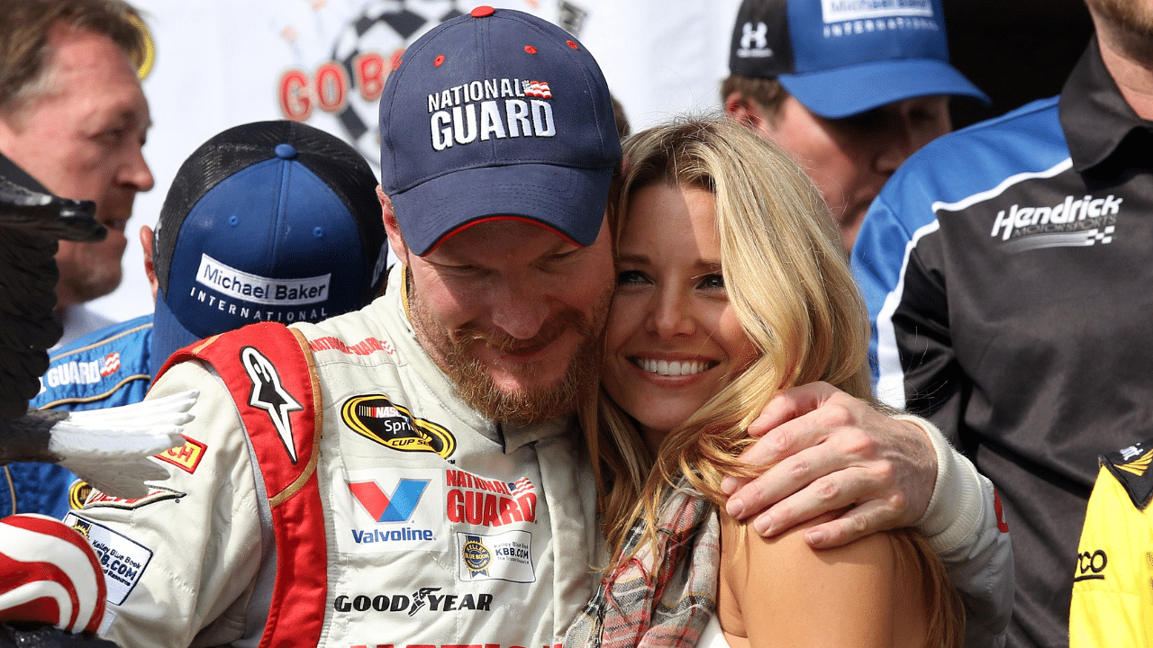 Aug 3, 2014; Long Pond, PA, USA; NASCAR Sprint Cup Series driver Dale Earnhardt Jr. (88) hugs his girlfriend Amy Reimann on victory lane after winning the GoBowling.com 400 at Pocono Raceway. Mandatory Credit: Bill Streicher-Imagn Images