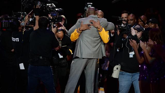 Los Angeles Lakers forward Kobe Bryant (facing camera) hugs former Laker player Magic Johnson before a game against the Utah Jazz at Staples Center.