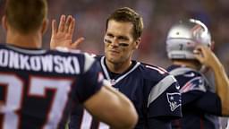 New England Patriots quarterback Tom Brady (12) and tight end Rob Gronkowski (87) react from the sideline after a touchdown against the Green Bay Packers during the first half in a preseason NFL football game at Gillette Stadium.