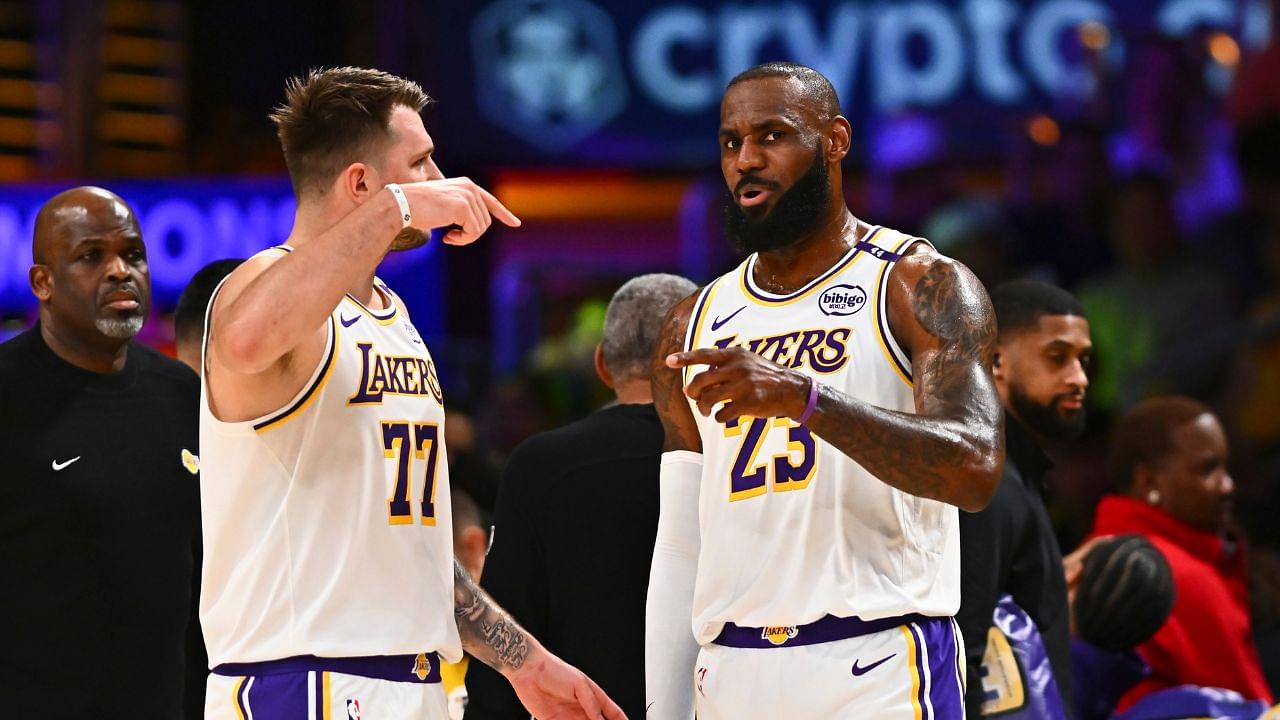 Los Angeles Lakers guard Luka Doncic (77) and Los Angeles Lakers forward LeBron James (23) on the sidelines against the Chicago Bulls during the first half at Crypto.com Arena.