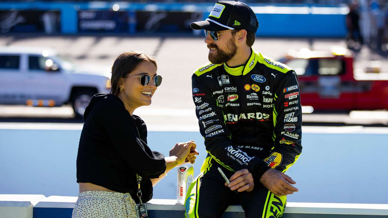 Nov 6, 2022; Avondale, Arizona, USA; NASCAR Cup Series driver Ryan Blaney (right) with girlfriend Gianna Tulio during the Cup Championship race at Phoenix Raceway. Mandatory Credit: Mark J. Rebilas-Imagn Images