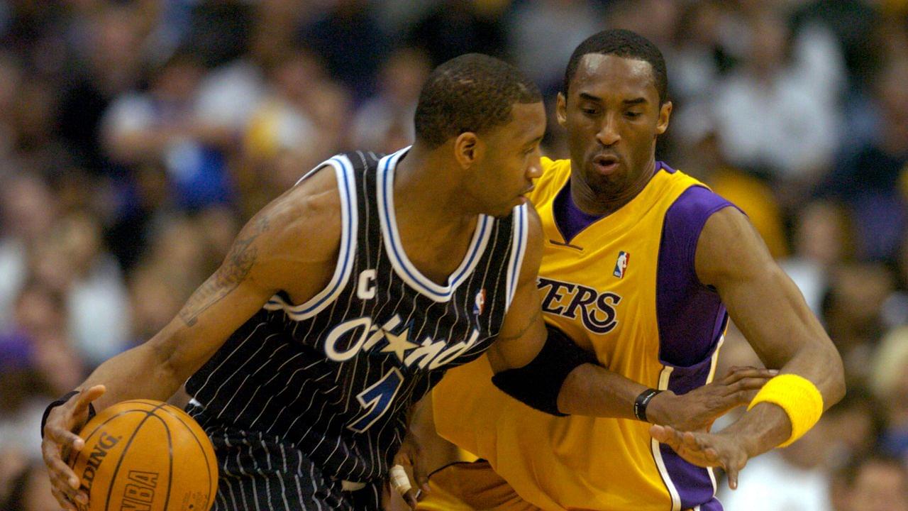 Tracy McGrady of the Orlando Magic is guarded by Los Angeles Lakers guard Kobe Bryant (8) during 113-110 overtime loss during an NBA basketball game, Monday, March 15, 2004, in Los Angeles.