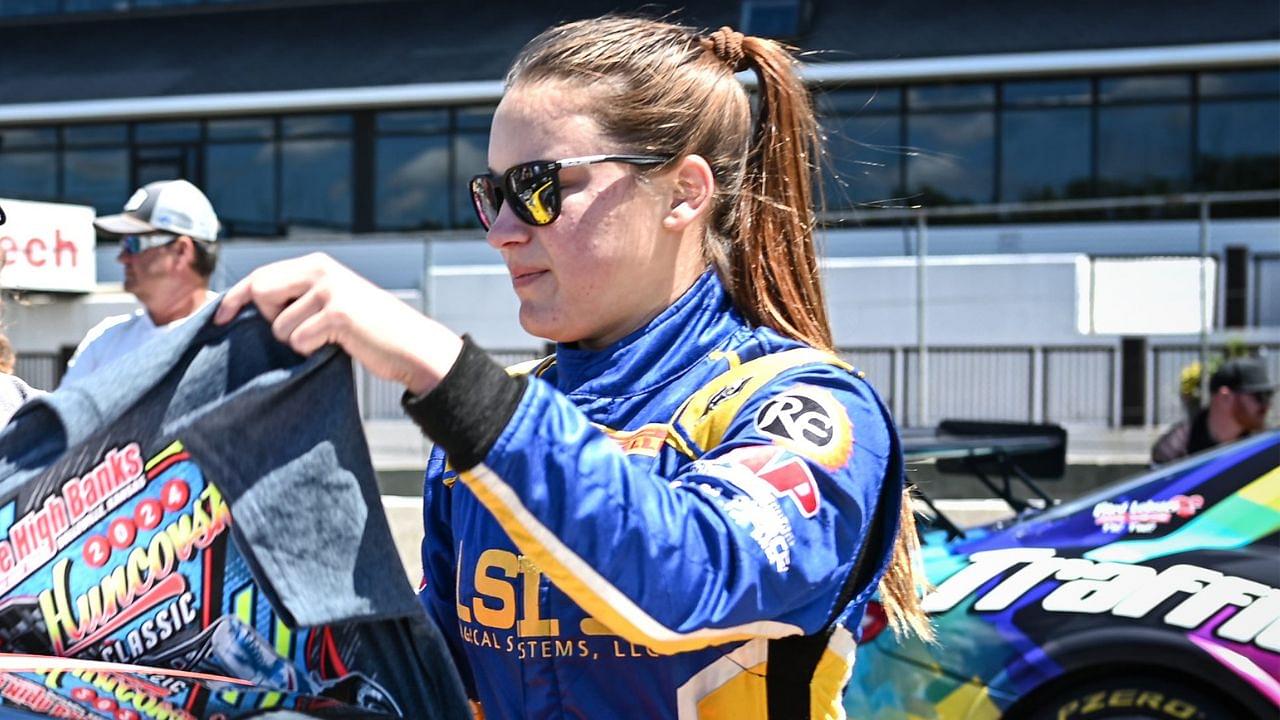 Kaylee Bryson signs an autograph during the grid walk before the Trans Am Speed Tour main event Sunday, June 30, 2024, at Road America in Elkhart Lake, Wisconsin.
