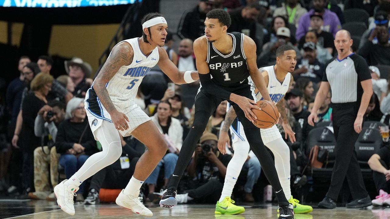 San Antonio Spurs center Victor Wembanyama (1) looks to pass in front of Orlando Magic forward Paolo Banchero (5) in the second half at Frost Bank Center.