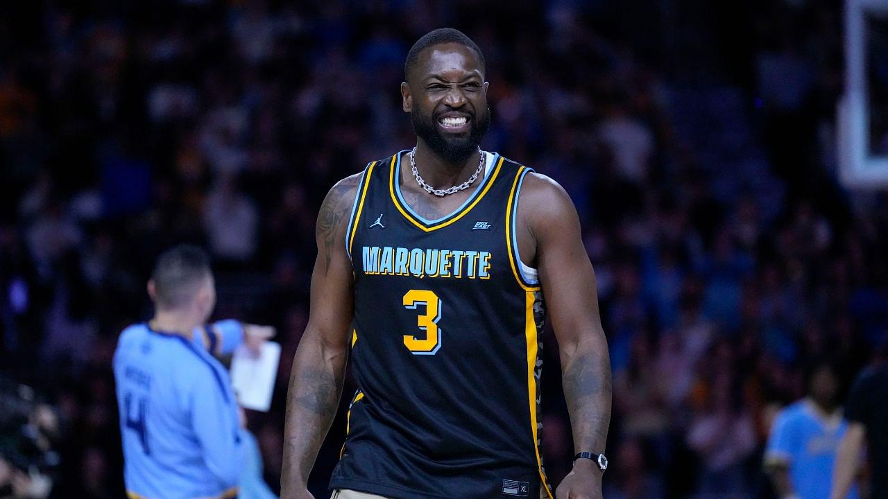 Former Marquette Golden Eagles player Dwyane Wade smiles timeout during the first half of the game against the Providence Friars at Fiserv Forum