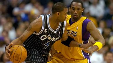 Tracy McGrady of the Orlando Magic is guarded by Los Angeles Lakers guard Kobe Bryant (8) during 113-110 overtime loss during an NBA basketball game, Monday, March 15, 2004, in Los Angeles.