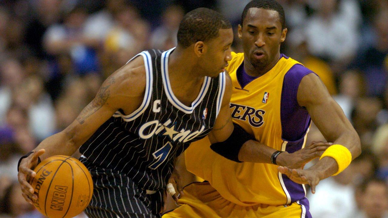 Tracy McGrady of the Orlando Magic is guarded by Los Angeles Lakers guard Kobe Bryant (8) during 113-110 overtime loss during an NBA basketball game, Monday, March 15, 2004, in Los Angeles.