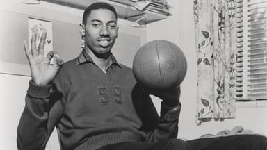 Wilt Chamberlain Smiling with Basketball Vintage 1960 s capture of Wilt Chamberlain smiling while spinning a basketball.