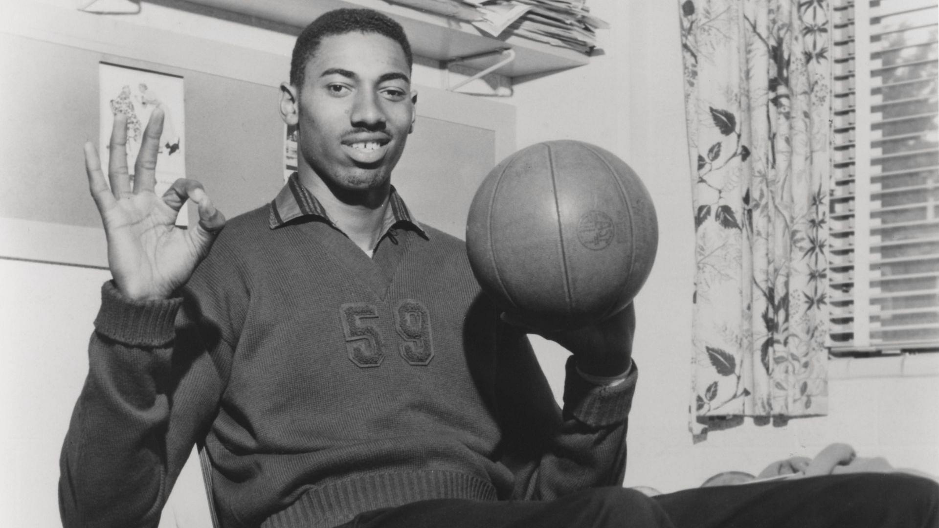 Wilt Chamberlain Smiling with Basketball Vintage 1960 s capture of Wilt Chamberlain smiling while spinning a basketball.