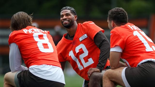 Browns quarterbacks Shedeur Sanders (12), Kenny Pickett (8) and Joe Flacco (15) talk during minicamp June 10, 2025, in Berea, Ohio.