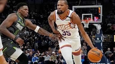 Phoenix Suns forward Kevin Durant (35) brings the ball up as Minnesota Timberwolves guard Anthony Edwards (5) defends him in the fourth quarter at Target Center.