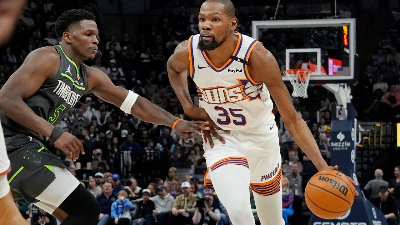 Phoenix Suns forward Kevin Durant (35) brings the ball up as Minnesota Timberwolves guard Anthony Edwards (5) defends him in the fourth quarter at Target Center.