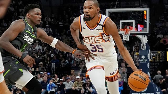 Phoenix Suns forward Kevin Durant (35) brings the ball up as Minnesota Timberwolves guard Anthony Edwards (5) defends him in the fourth quarter at Target Center.