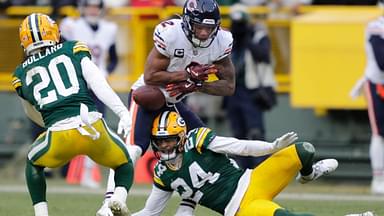 Chicago Bears wide receiver DJ Moore (2) fumbles the ball against Green Bay Packers safety Javon Bullard (20) and cornerback Carrington Valentine (24) late in the fourth quarter during their football game Sunday, January 5, 2025, at Lambeau Field in Green Bay, Wisconsin. Bullard recovered the fumble.