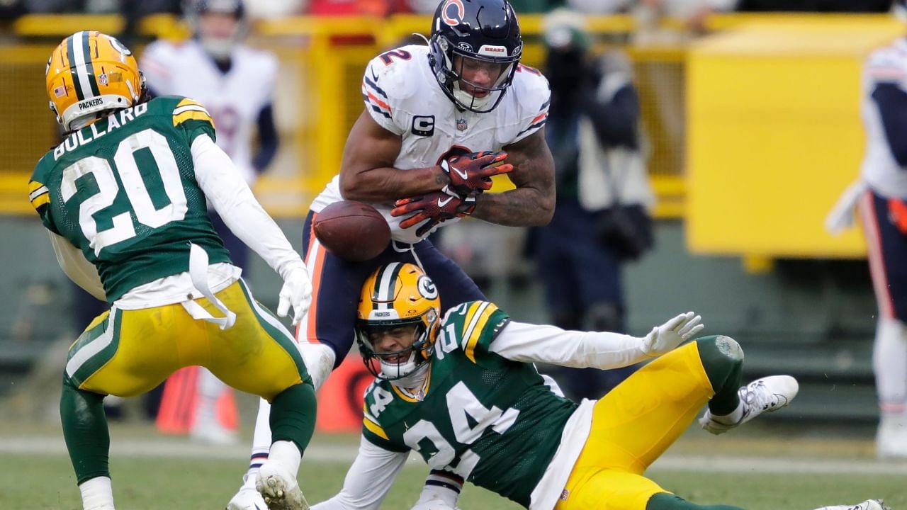 Chicago Bears wide receiver DJ Moore (2) fumbles the ball against Green Bay Packers safety Javon Bullard (20) and cornerback Carrington Valentine (24) late in the fourth quarter during their football game Sunday, January 5, 2025, at Lambeau Field in Green Bay, Wisconsin. Bullard recovered the fumble.