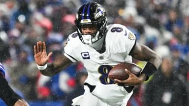 Jan 19, 2025; Orchard Park, New York, USA; Baltimore Ravens quarterback Lamar Jackson (8) runs the ball against Buffalo Bills safety Damar Hamlin (3) during the fourth quarter in a 2025 AFC divisional round game at Highmark Stadium.