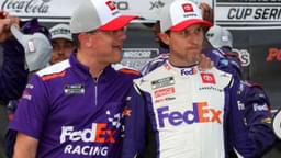 NASCAR Cup Series driver Denny Hamlin (right) is congratulated by crew chief Chris Gabehart (left) in victory lane after winning the M&M's Fan Appreciation 400 at Pocono Raceway.
