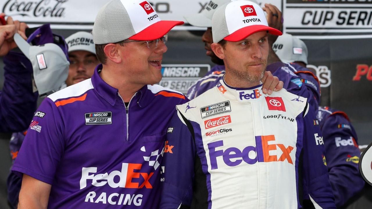NASCAR Cup Series driver Denny Hamlin (right) is congratulated by crew chief Chris Gabehart (left) in victory lane after winning the M&M's Fan Appreciation 400 at Pocono Raceway.