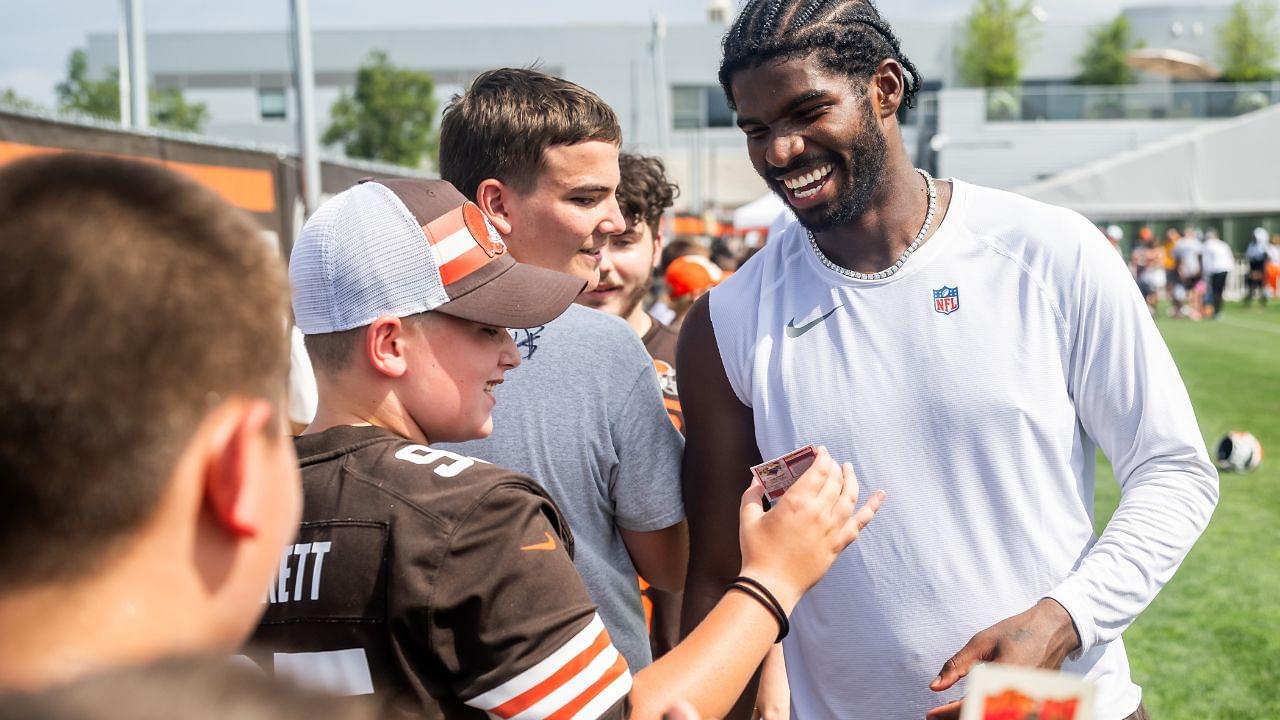 Cleveland Browns quarterback Shedeur Sanders (12) talks to a fan during training camp at CrossCountry Mortgage Campus.